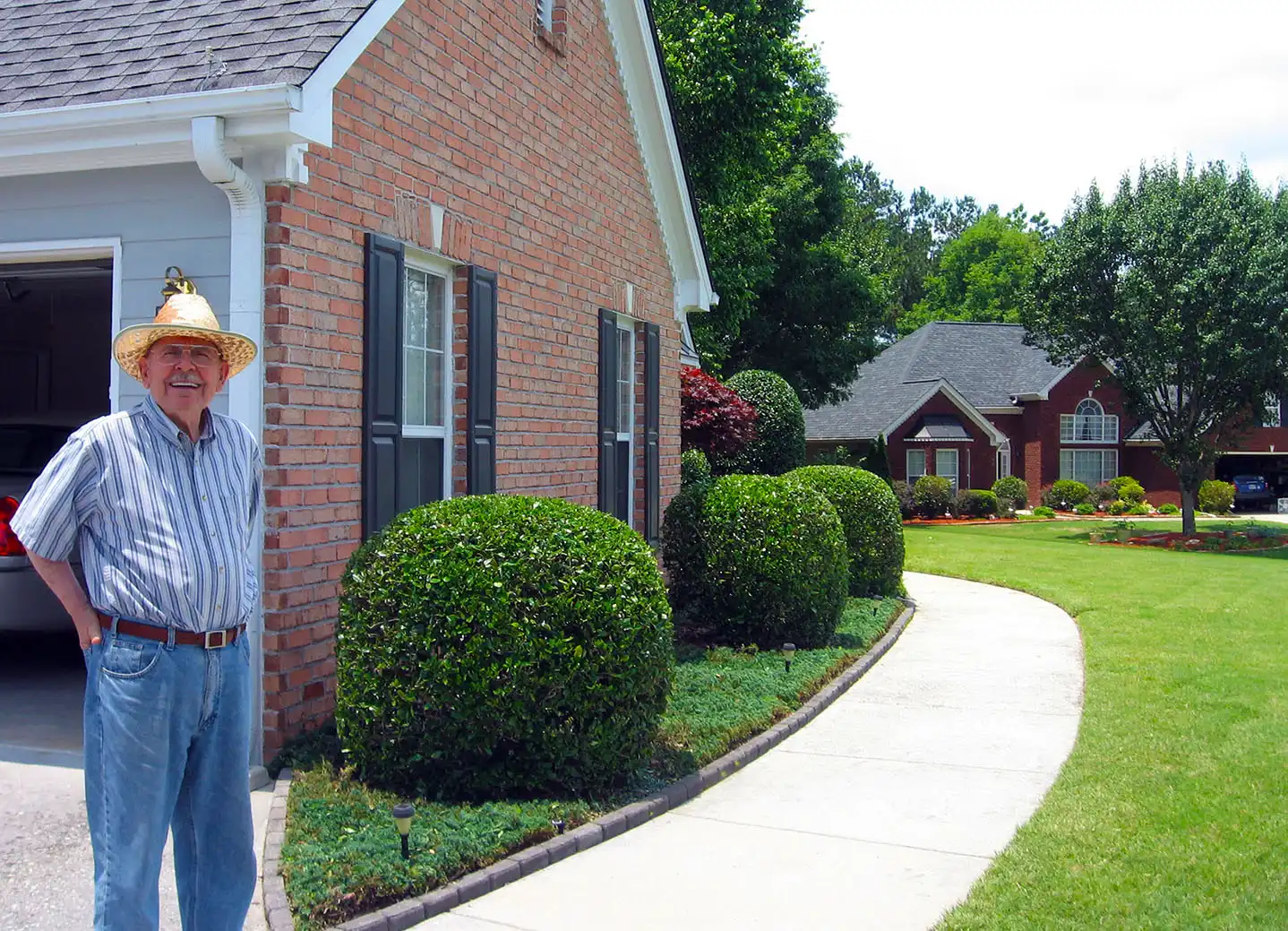 Happy customer with freshly trimmed hedges